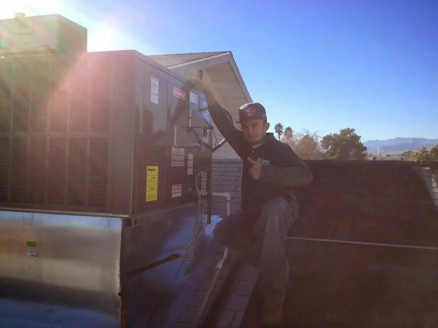 HVAC technician performing HVAC Inspection on a rooftop unit in Moraine
